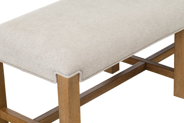 Wooden bench with a beige cushion on a white background